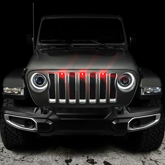 Front end of a Jeep Wrangler with red LED Grill Light Kit installed.