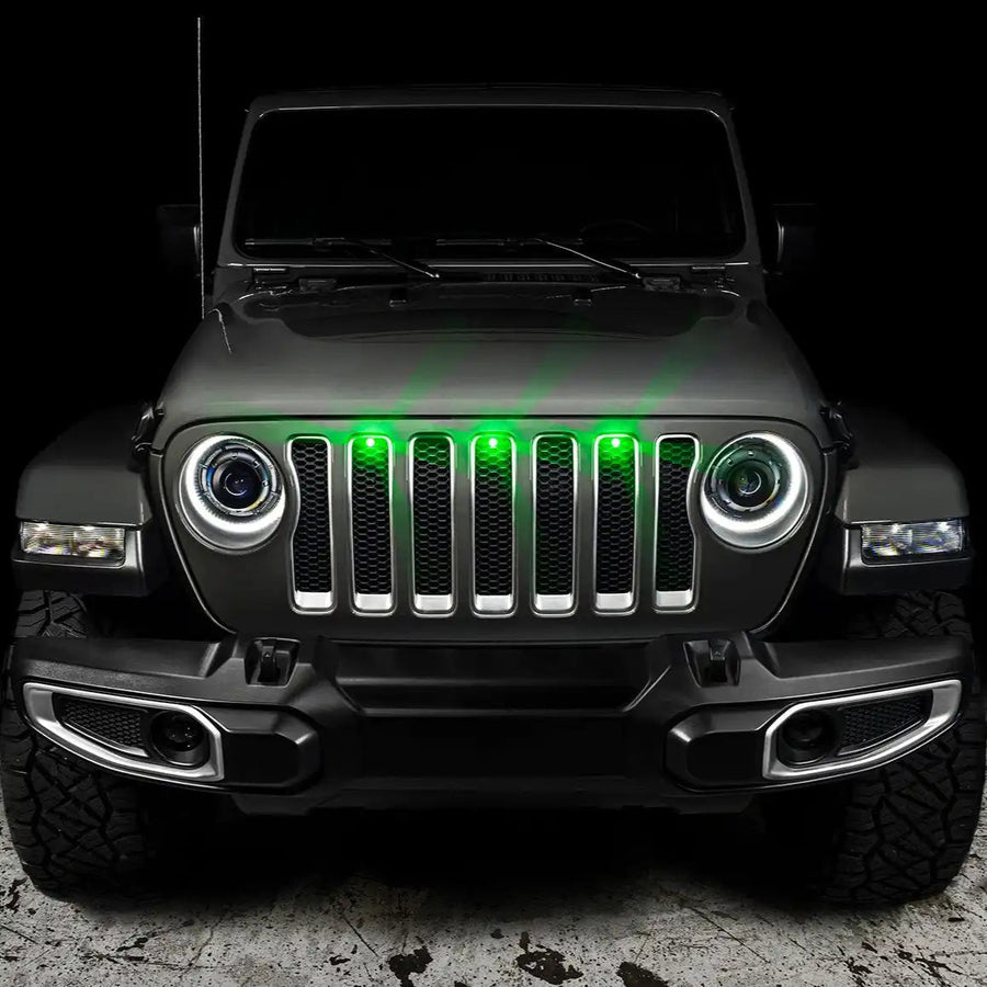 Front end of a Jeep Wrangler with green LED Grill Light Kit installed.