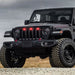 Three quarters view of a black Jeep Gladiator JT with red Pre-Runner Style LED Grill Light Kit installed.