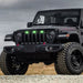 Three quarters view of a black Jeep Gladiator JT with green Pre-Runner Style LED Grill Light Kit installed.