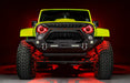 Front view of a yellow Jeep with 7" Oculus Headlights installed, set to red LEDs.