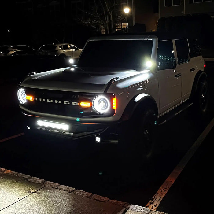 White Ford Bronco with Oculus Headlights installed and turned on.