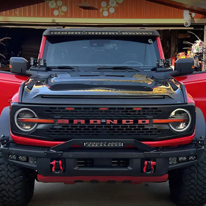 Front view of a red Ford Bronco equipped with the Integrated Windshield Roof LED Light Bar System.