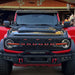 Front view of a red Ford Bronco equipped with the Integrated Windshield Roof LED Light Bar System.
