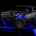 Three quarters view of wrapped Ford Bronco with blue LED rock lights installed