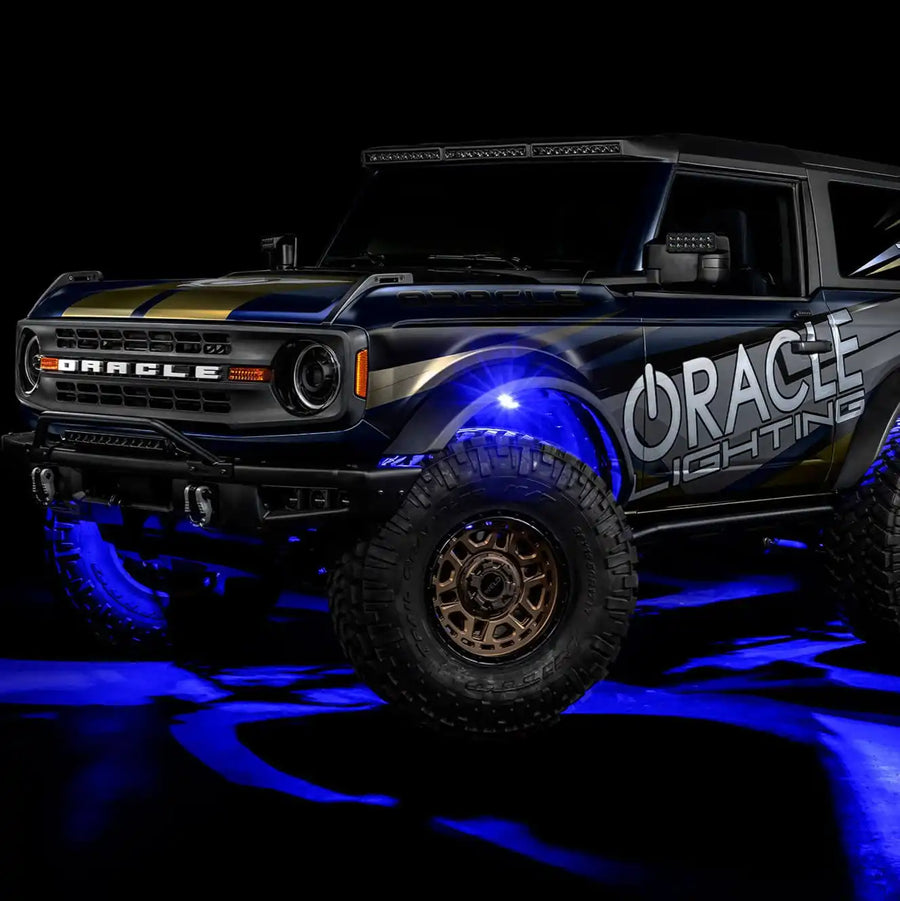 Three quarters view of wrapped Ford Bronco with blue LED rock lights installed