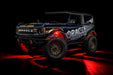 Three quarters view of wrapped Ford Bronco with red LED rock lights installed