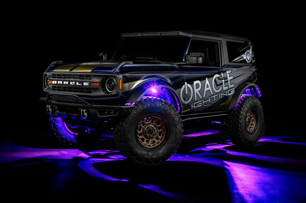 Three quarters view of wrapped Ford Bronco with purple LED rock lights installed