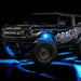 Three quarters view of wrapped Ford Bronco with cyan LED rock lights installed