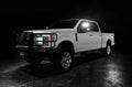 Three quarters view of a white Ford SuperDuty with LED Off-Road Side Mirrors turned on.