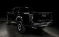 Rear three quarters view of black Toyota Tacoma with tinted Flush Style LED Tail Lights installed