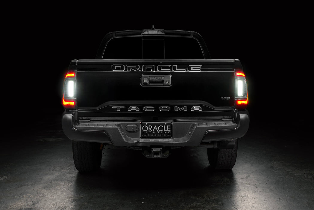 Straight rear view of black Toyota Tacoma with Flush Style LED Tail Lights installed and reverse lights on