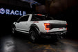 Rear three quarters view of white Ford Raptor with brake lights on