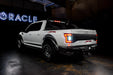 Rear three quarters view of white Ford Raptor with reverse lights on