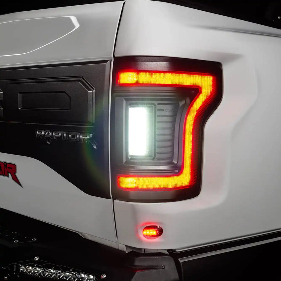Close up of Flush Style LED Tail Lights installed on white Ford Raptor with reverse lights on