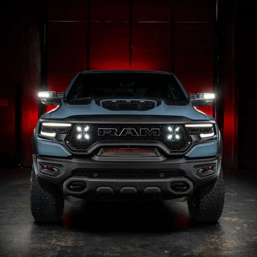 Straight front view of a RAM TRX with LED Off-Road Side Mirror Ditch Lights installed and turned on