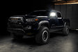 Front three quarters view of black Toyota Tacoma with glowing side mirrors