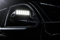 Close up of glowing LED Off-Road Side Mirror Ditch Lights installed on Toyota Tacoma