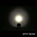 Light fixture emitting a spot beam in a dark setting with 'SPOT BEAM' text below.