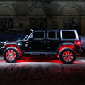 Side view of black Jeep with red LED wheel rings.
