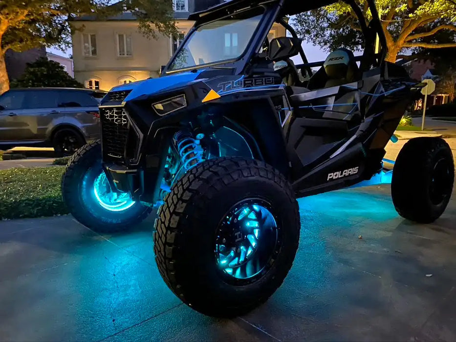 Polaris RZR with aqua LED wheel rings.