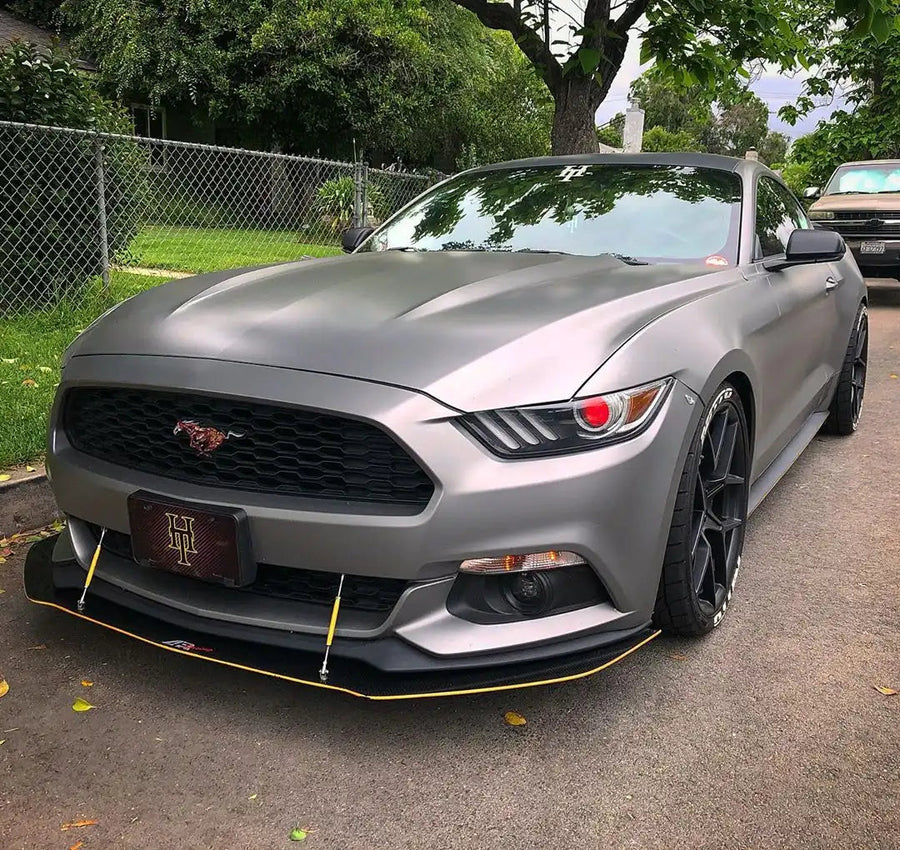 Three quarters view of a Ford Mustang with red demon eye projector headlights.