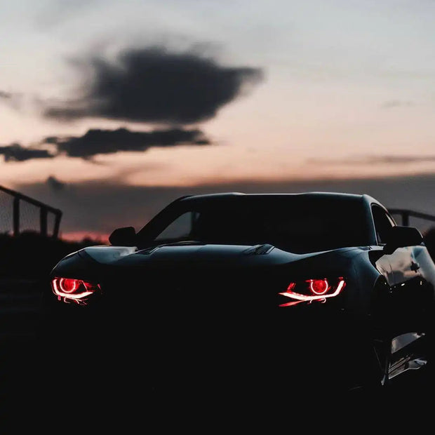 Camaro at sunset with red demon eyes
