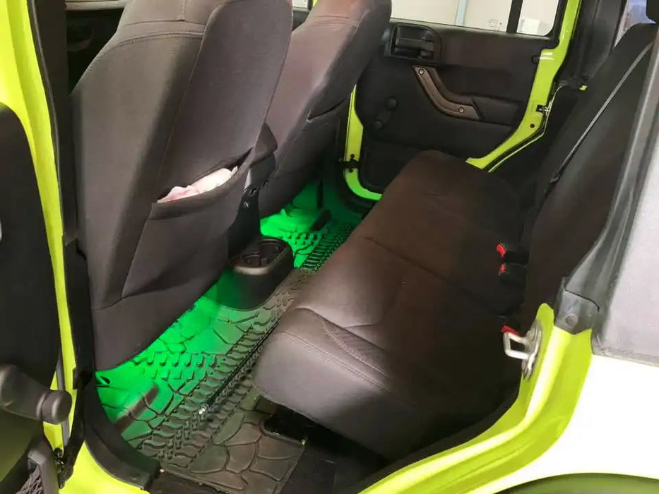 Backseat of a Jeep with green LED footwell lighting.