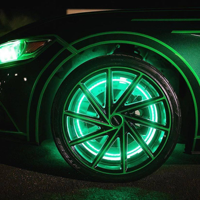 Close up of a Ford Mustang with green LED wheel rings.