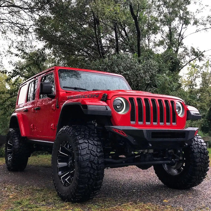Three quarters view of a red Jeep Wrangler with Oculus Headlights installed.