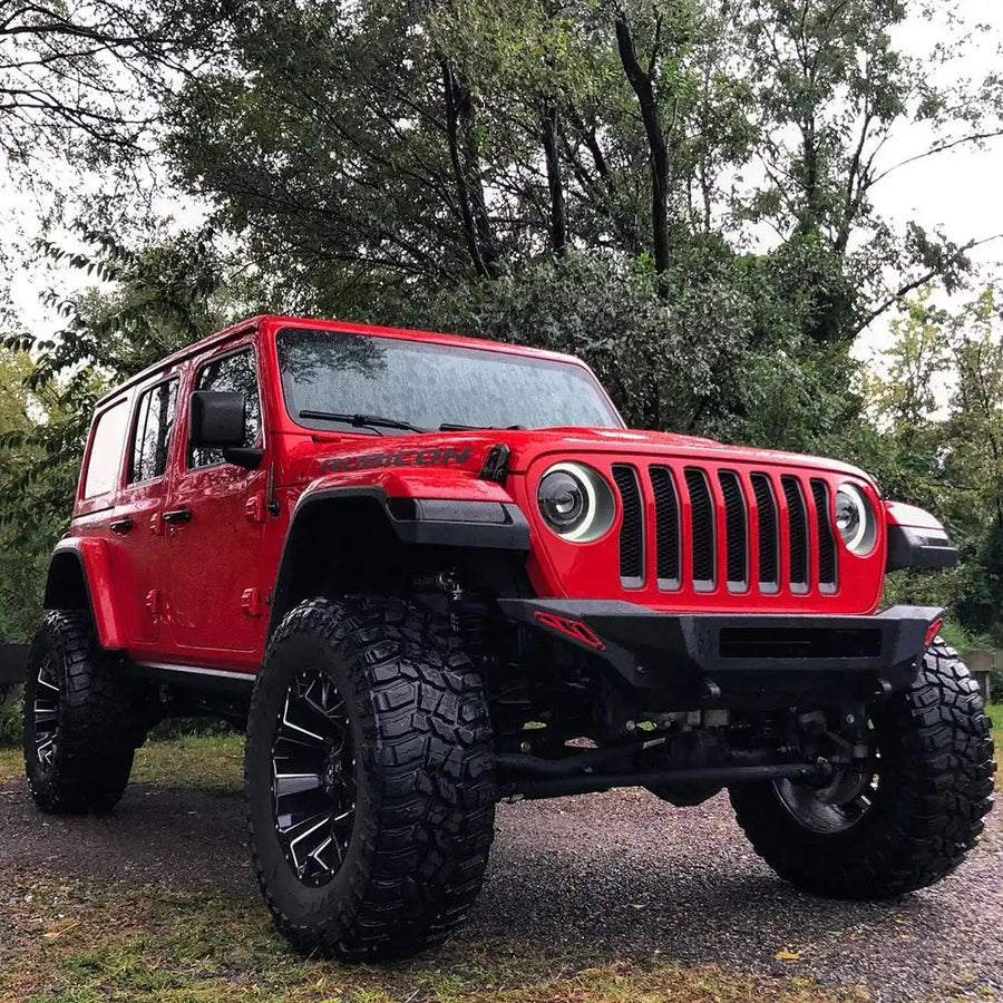 Three quarters view of a red Jeep Wrangler with Oculus Headlights installed.