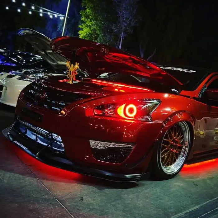 A red Nissan with red halos and red LED underbody kit.