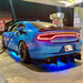 A blue Charger at a gas station with a blue LED underbody kit.