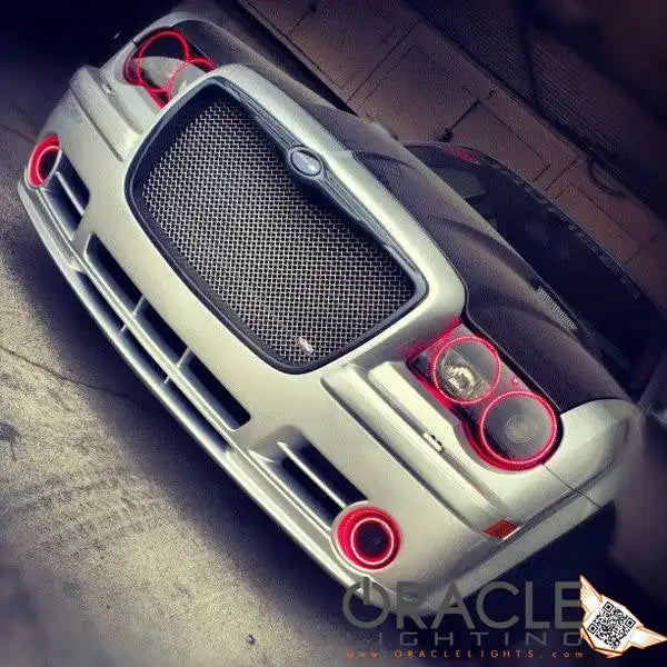 Front end of a Chrysler 300C with red LED headlight and fog light halo rings installed.