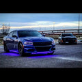 Three quarters view of a blue Dodge Charger with pink headlight DRLs.