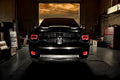Front end of a RAM truck with Switchback Quad Pre-Assembled Halo Headlights installed and red halos on.