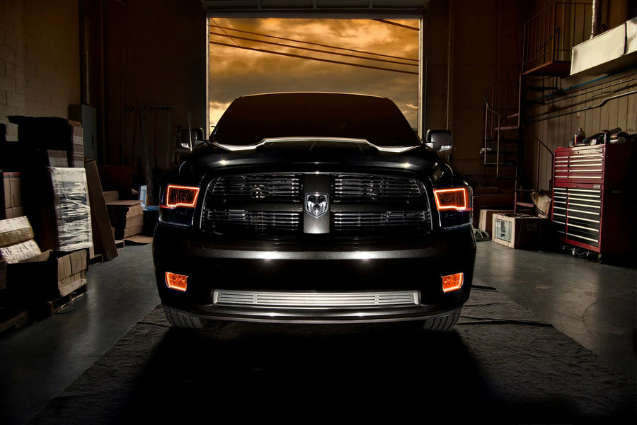 Front end of a RAM truck with Switchback Quad Pre-Assembled Halo Headlights installed and amber halos on.