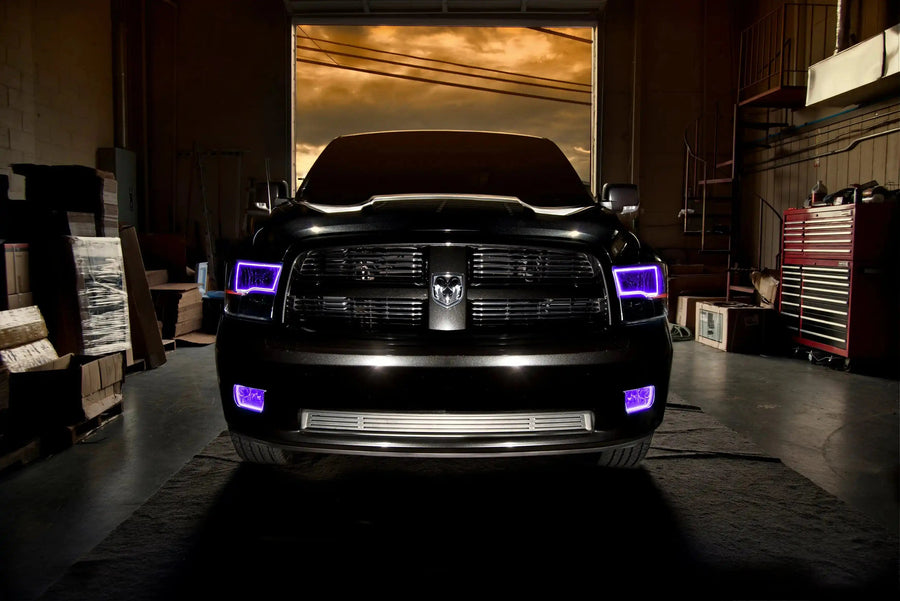 Front end of a RAM truck with Switchback Quad Pre-Assembled Halo Headlights installed and purple halos on.