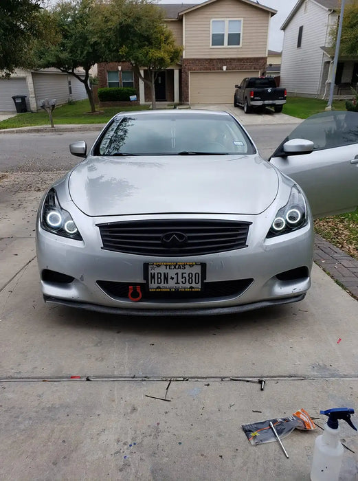 Front end of an Infiniti G37 with white LED headlight halo rings installed.