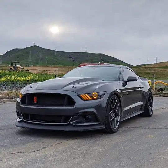 Three quarters view of a Ford Mustang with amber headlight halos and DRLs.
