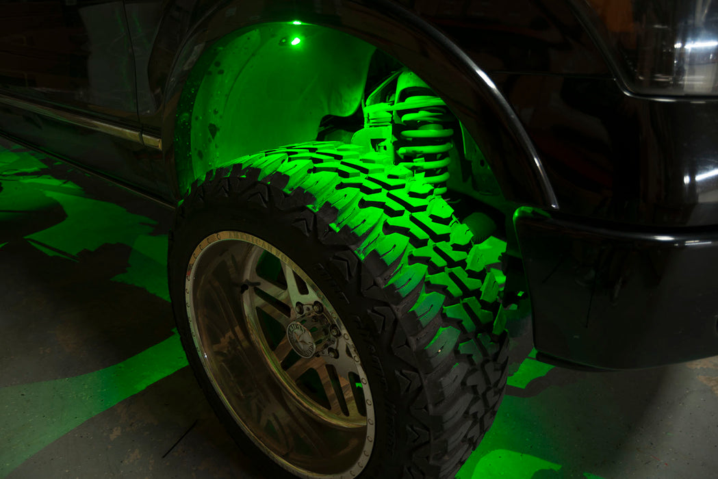 Close-up of wheel well with green rock light glowing