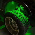Close-up of wheel well with green rock light glowing.