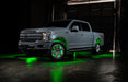 Grey Ford F-150 with green wheel rings and rock lights.