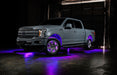 Grey Ford F-150 with purple wheel rings and rock lights.