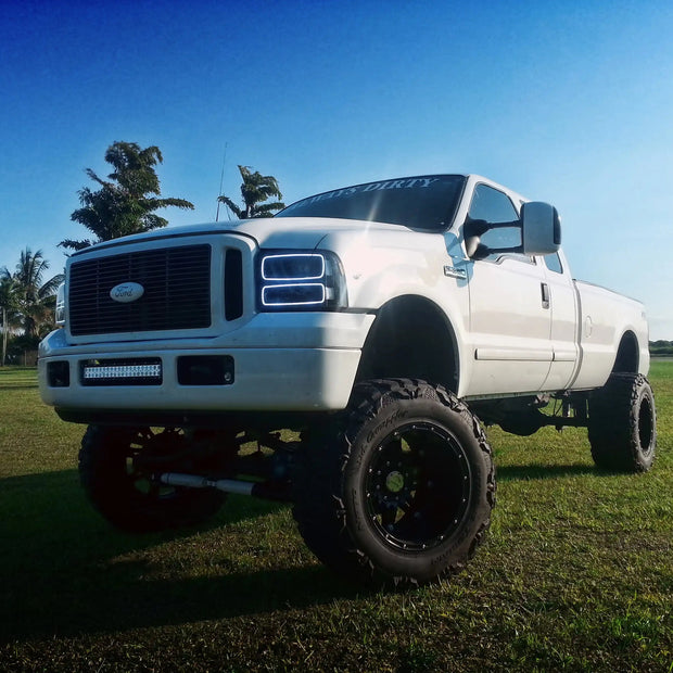 Three quarters view of a Ford Super Duty with white LED headlight halo rings installed.