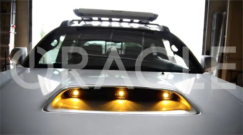 Close-up of grill vent with yellow billet lights