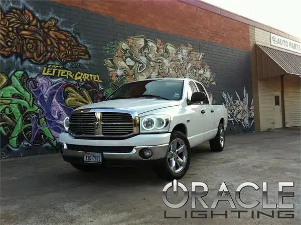 Three quarters view of a Dodge Ram with white LED headlight halo rings installed.