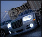 Front end of a Chrysler 300C with white LED headlight and fog light halo rings installed.