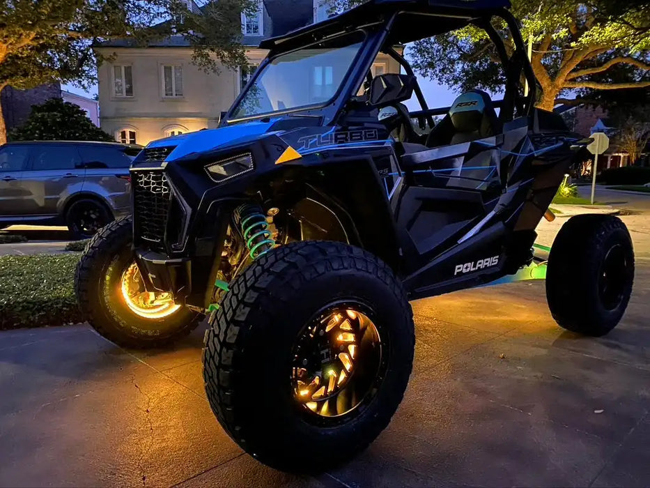 Polaris RZR with yellow LED illuminated wheel rings.