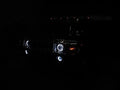 Front end of a Hummer H2 with white LED headlight and fog light halos.